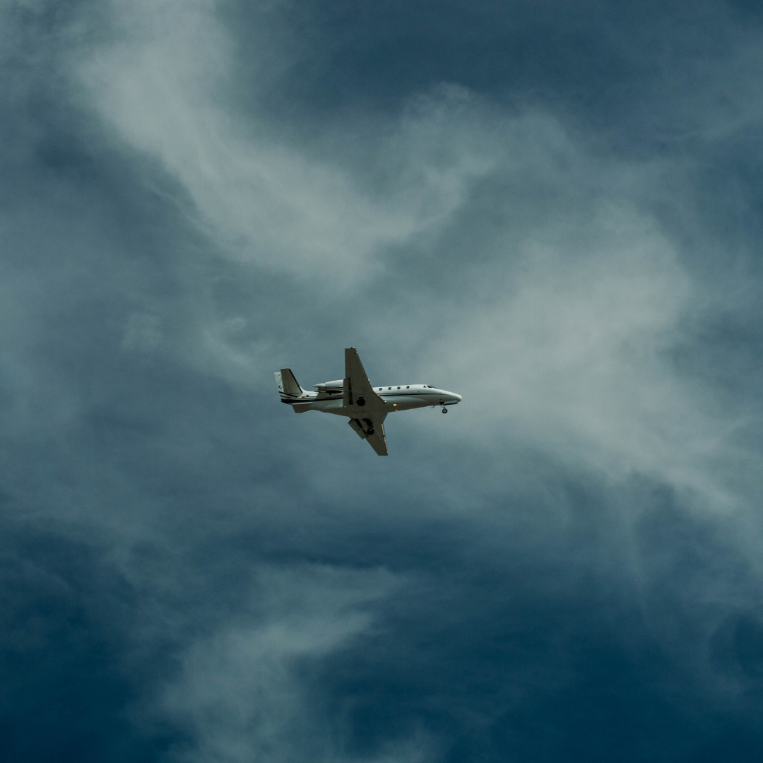 On Demand Private Jet Charter in a cloudy sky